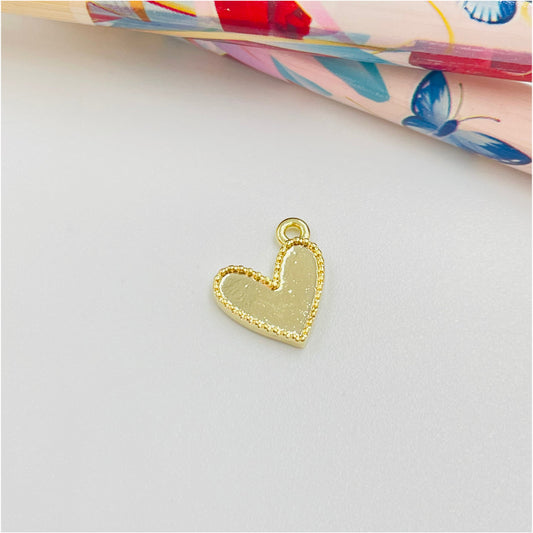 FO889 Colgante Mini Corazón ladeado con borde reticulado 9 mm más argollita Figura Baño Oro Figuras Bañadas en Oro y Plata hecho de Bronce Bañado en Oro 18K Joyas Bañadas en Oro
