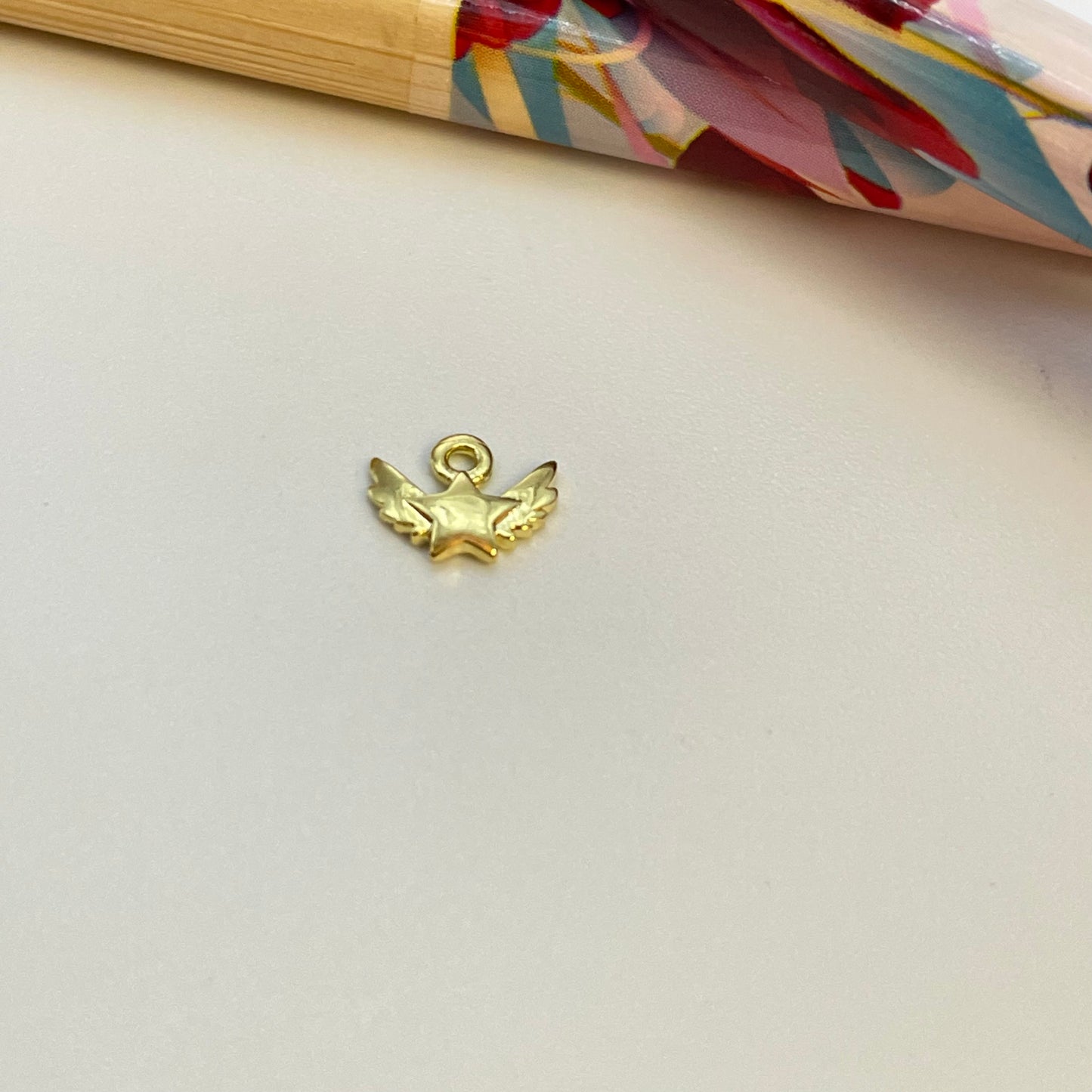 FO1020 Colgante mini estrella Alada 5 x 7 mm mas argollita Figura Baño Oro
